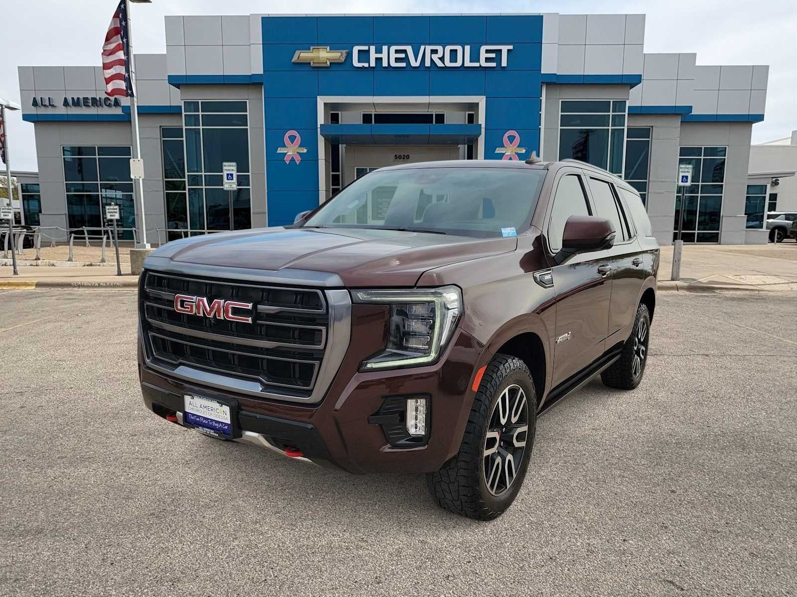 2023 GMC Yukon AT4 in Redwood Metallic — front three-quarter view